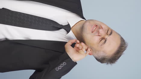Vertical-video-of-Businessman-scratching-his-ear.